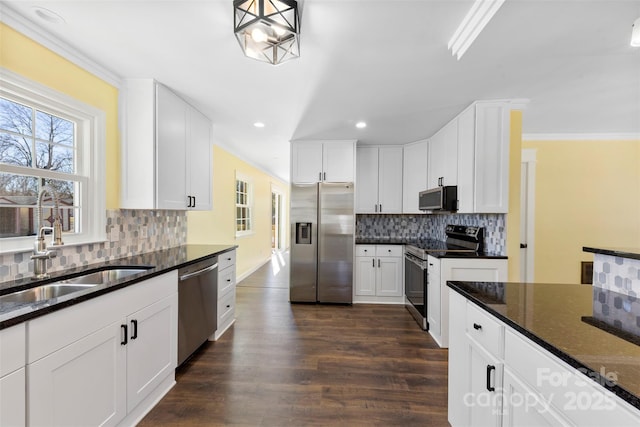 kitchen featuring stainless steel appliances, dark wood-type flooring, and backsplash