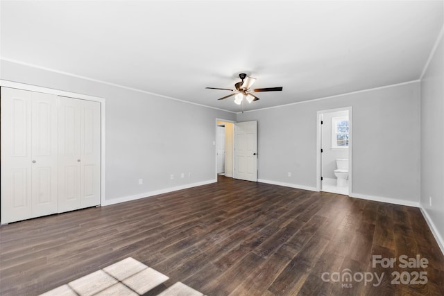 unfurnished bedroom featuring ornamental molding, ensuite bath, baseboards, and wood finished floors