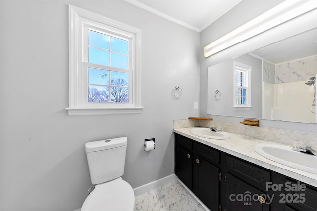 full bathroom featuring toilet, baseboards, ornamental molding, and a sink