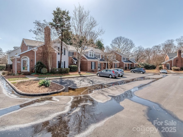 view of road featuring curbs, sidewalks, and a residential view