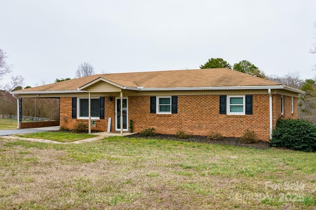 ranch-style home featuring brick siding and a front yard