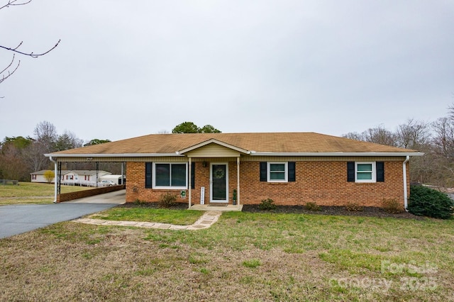 single story home with brick siding, aphalt driveway, an attached carport, and a front lawn