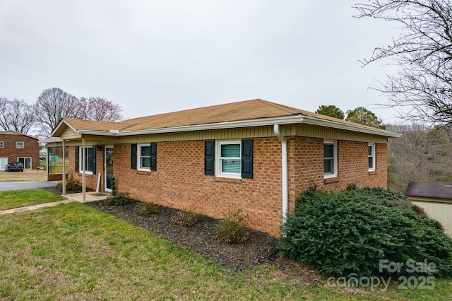 view of front of home featuring a front yard and brick siding