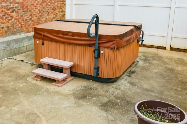 exterior details with a jacuzzi and brick siding