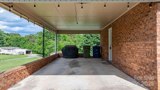 2609 Raintree St, Connelly Springs, NC 28612 - view of patio featuring an attached carport and a forest view