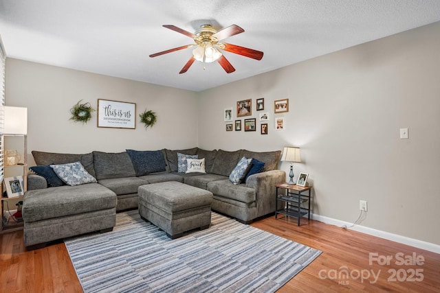 2609 Raintree St, Connelly Springs, NC 28612 - living area with a ceiling fan, wood finished floors, and baseboards