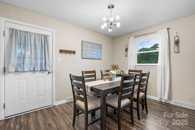 2609 Raintree St, Connelly Springs, NC 28612 - dining area with dark wood-style floors, a chandelier, baseboards, and a textured ceiling