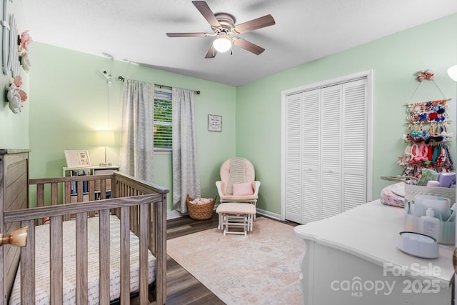 2609 Raintree St, Connelly Springs, NC 28612 - bedroom featuring a closet, a crib, wood finished floors, and a ceiling fan