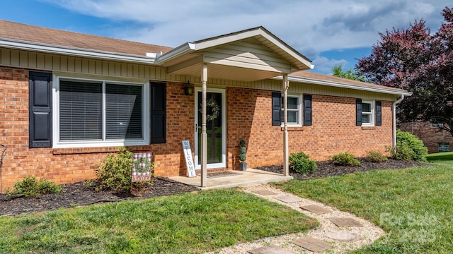 2609 Raintree St, Connelly Springs, NC 28612 - view of front of home featuring a front yard, brick siding, and roof with shingles