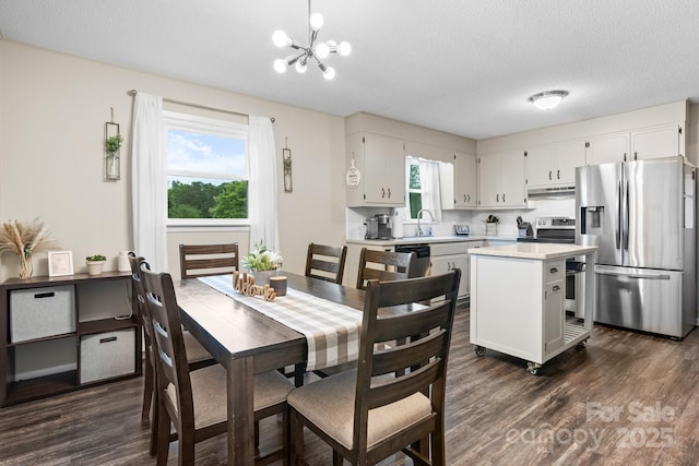 2609 Raintree St, Connelly Springs, NC 28612 - dining space with a chandelier, dark wood-style flooring, and a textured ceiling