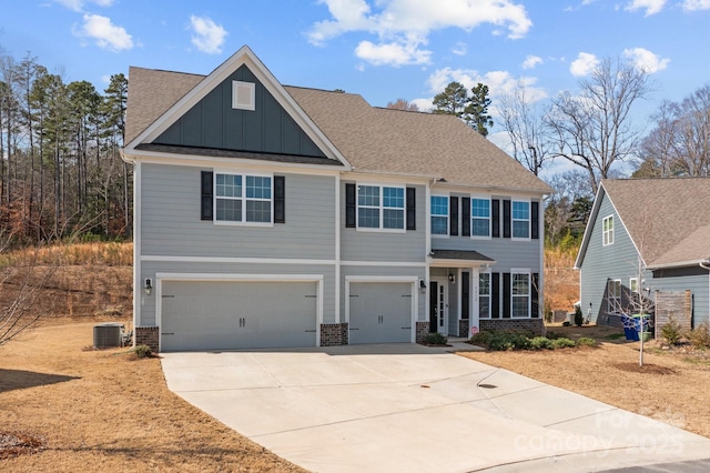 view of front of property featuring a garage, concrete driveway, central air condition unit, board and batten siding, and brick siding