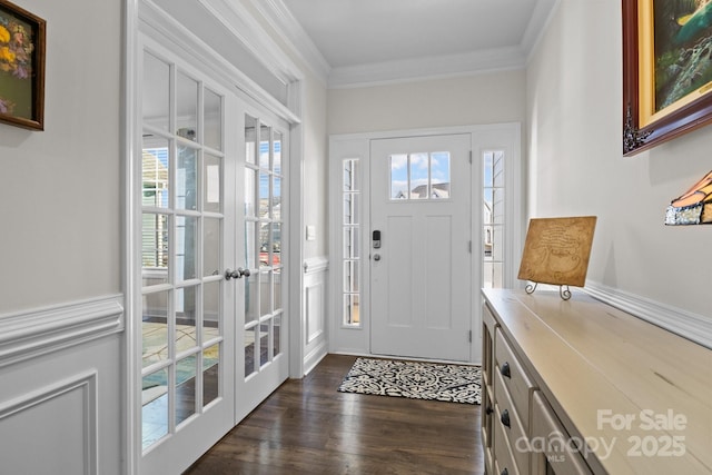 entrance foyer featuring ornamental molding, french doors, and dark wood finished floors