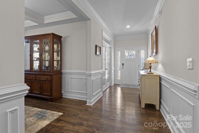 foyer featuring ornamental molding, dark wood-style flooring, and a wealth of natural light