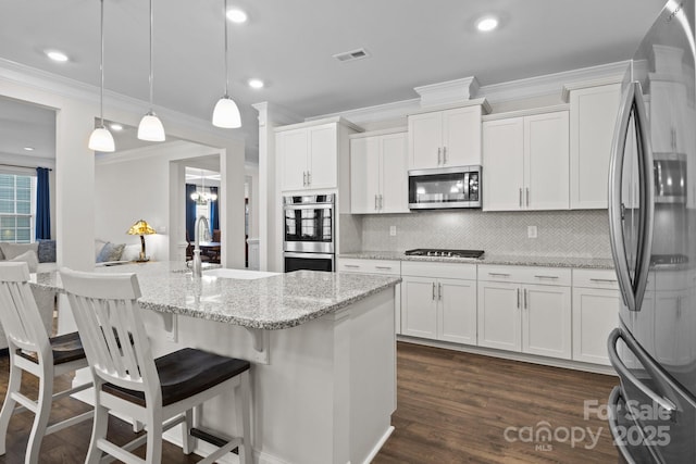 kitchen with visible vents, white cabinets, dark wood-style floors, appliances with stainless steel finishes, and a sink