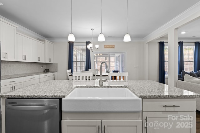 kitchen with crown molding, tasteful backsplash, stainless steel dishwasher, white cabinets, and a sink