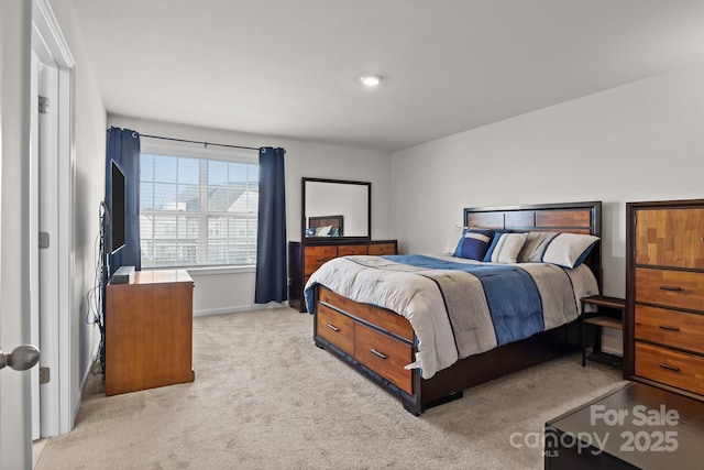 bedroom featuring light carpet and baseboards