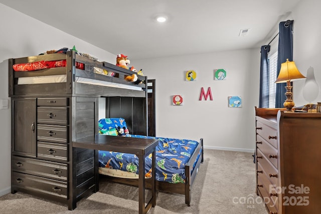 carpeted bedroom featuring visible vents and baseboards