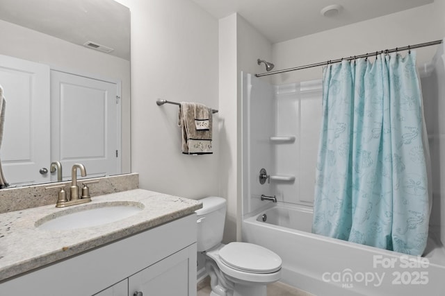 bathroom featuring visible vents, vanity, shower / bath combo with shower curtain, and toilet