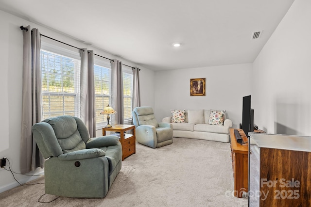 living room with light colored carpet and visible vents