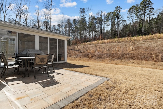 view of patio / terrace featuring outdoor dining space and a sunroom