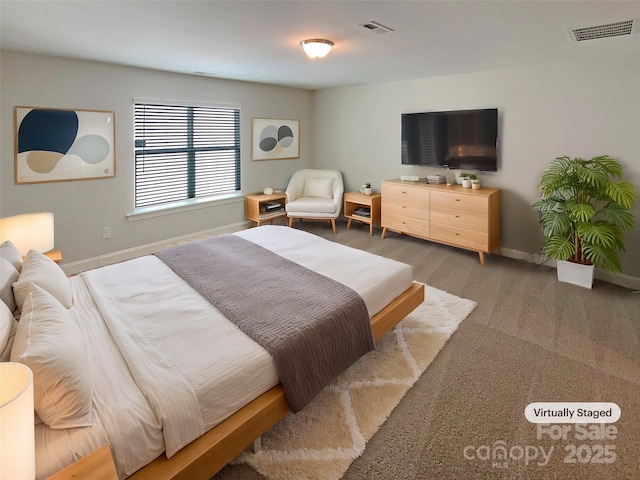 bedroom featuring baseboards and visible vents