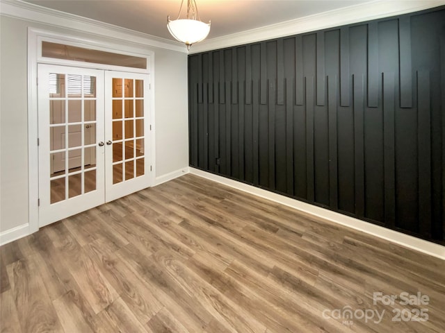 unfurnished room with ornamental molding, french doors, and wood finished floors