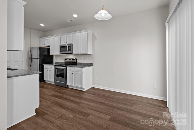 kitchen with dark wood-style floors, baseboards, white cabinetry, and stainless steel appliances