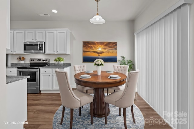 dining room featuring recessed lighting, visible vents, and dark wood finished floors