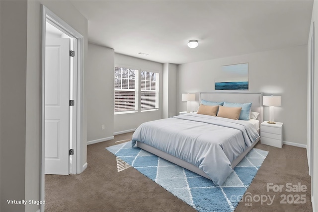 carpeted bedroom featuring visible vents and baseboards