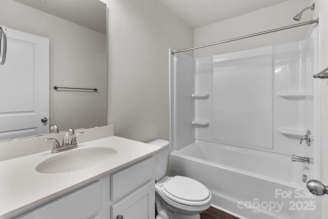 bathroom with vanity, toilet, and shower / bathtub combination