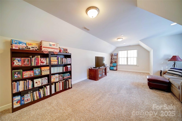 sitting room featuring baseboards, carpet, and lofted ceiling