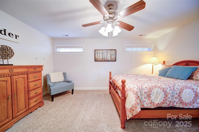 bedroom with light colored carpet, a ceiling fan, baseboards, and visible vents