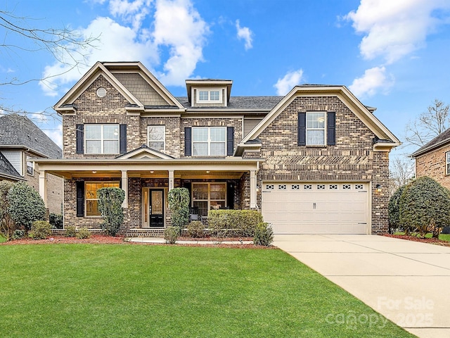 view of front facade with driveway, a front lawn, covered porch, a garage, and brick siding