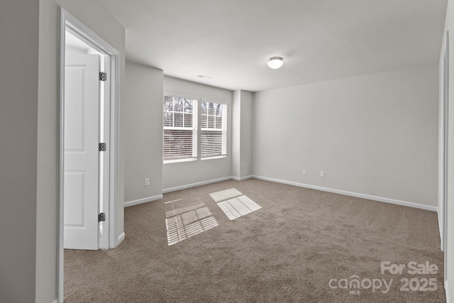 empty room with carpet floors and baseboards