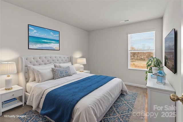 bedroom featuring baseboards and visible vents