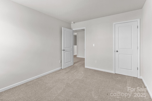 unfurnished bedroom with baseboards and carpet flooring