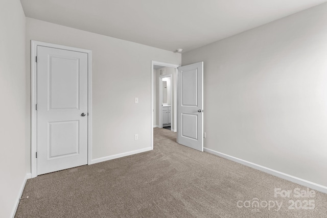 unfurnished bedroom featuring carpet and baseboards