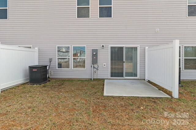 back of property with a yard, a patio, fence, and central air condition unit