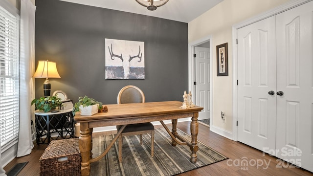 office space with wood finished floors, visible vents, a wealth of natural light, and baseboards