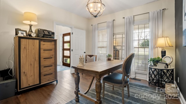 office area with dark wood finished floors and an inviting chandelier