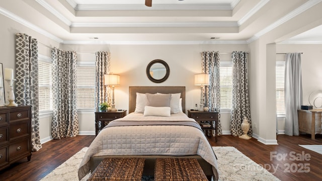 bedroom with ceiling fan, baseboards, dark wood finished floors, ornamental molding, and a raised ceiling