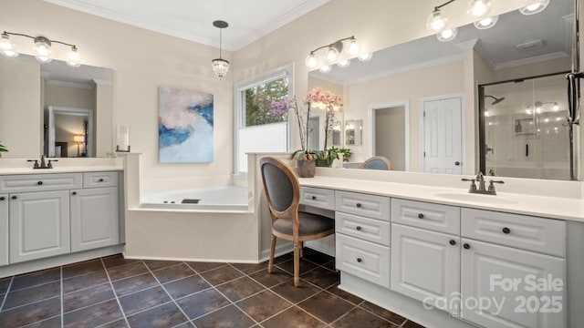 bathroom with ornamental molding, a stall shower, a garden tub, and a sink