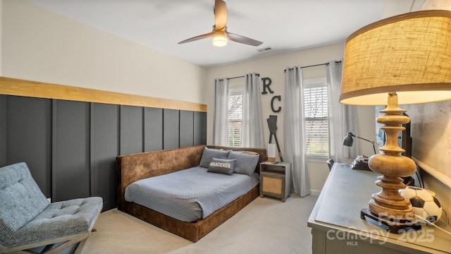 carpeted bedroom featuring visible vents and ceiling fan