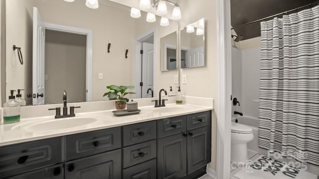 bathroom featuring a sink, shower / tub combo, toilet, and double vanity