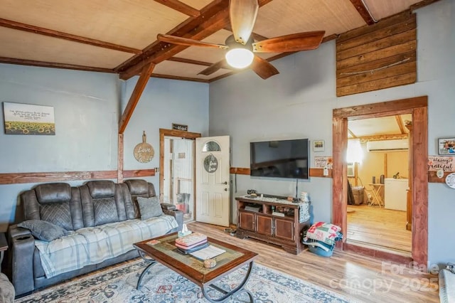 living room with ceiling fan, a wall mounted AC, lofted ceiling with beams, and wood finished floors