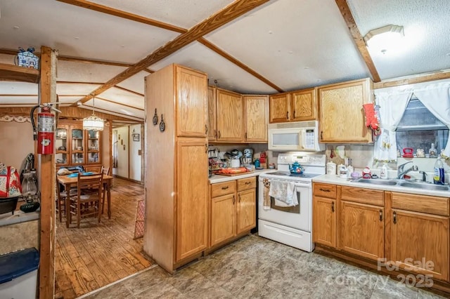 kitchen featuring lofted ceiling with beams, white appliances, light countertops, and a sink