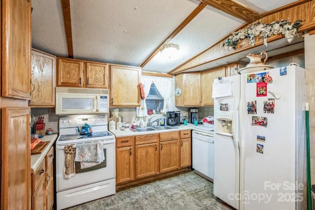 kitchen featuring lofted ceiling, light countertops, white appliances, and a sink