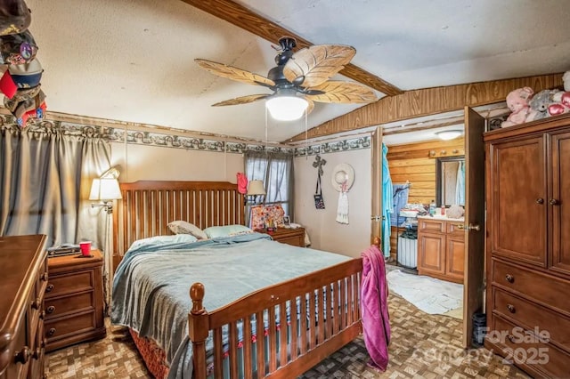 bedroom featuring vaulted ceiling with beams, wooden walls, and a ceiling fan