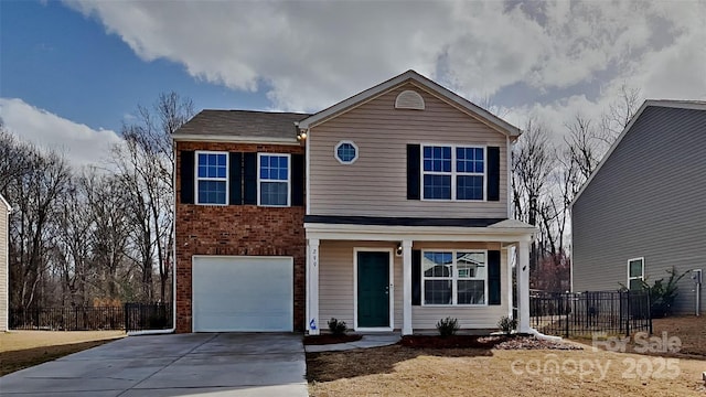 traditional home featuring brick siding, an attached garage, concrete driveway, and fence