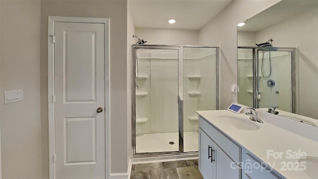 full bathroom with a stall shower, vanity, and wood finished floors